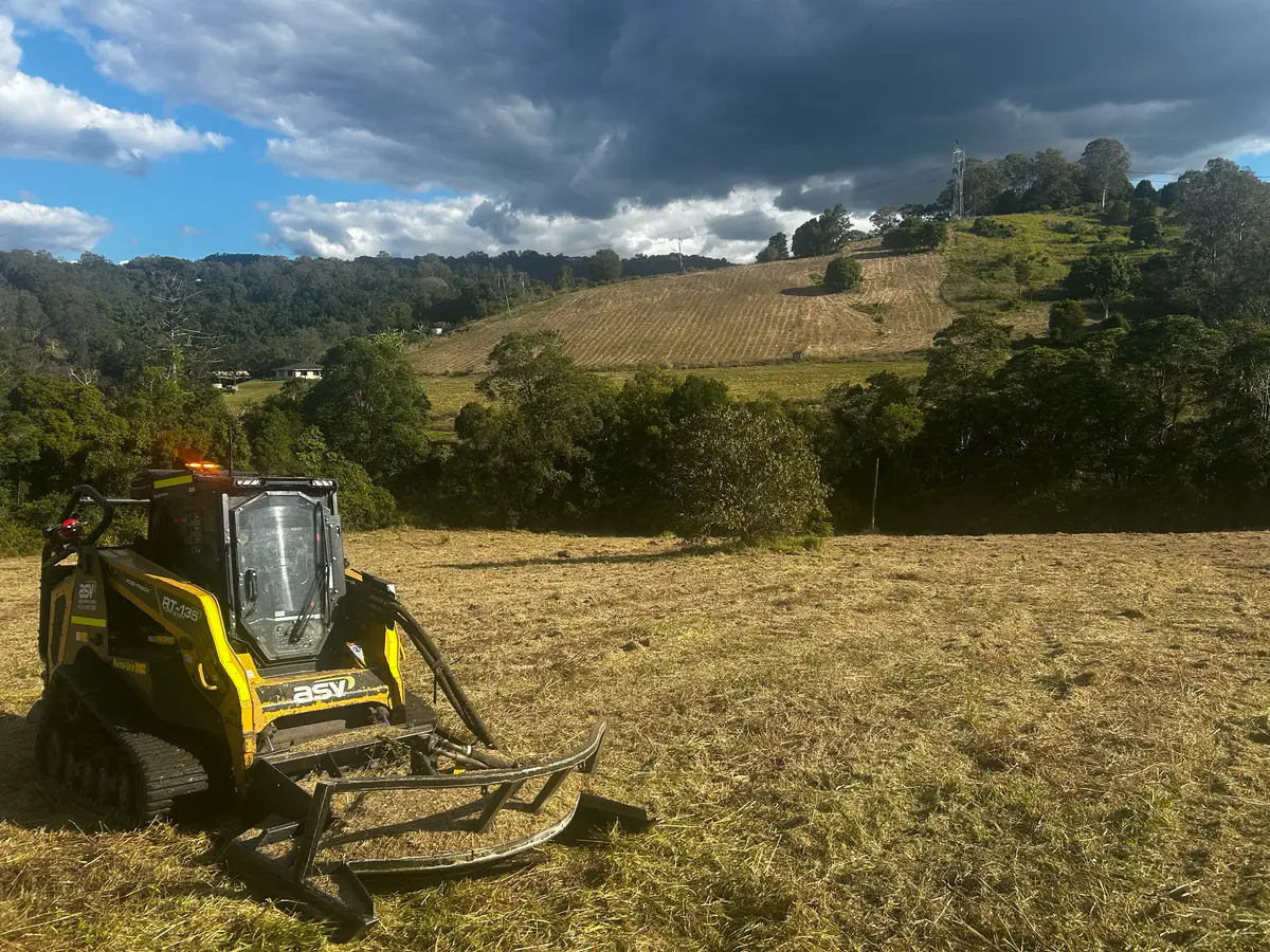 Machine slashing overgrown vegetation on a rural block in Queensland