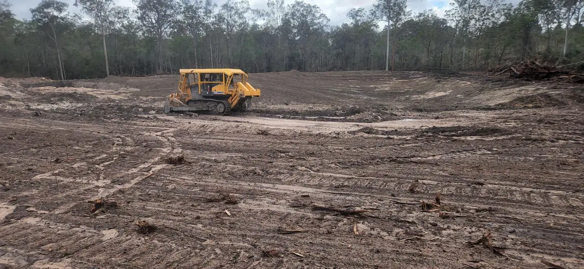 Stick rake dozer working cleared ground on a rural property in Queensland